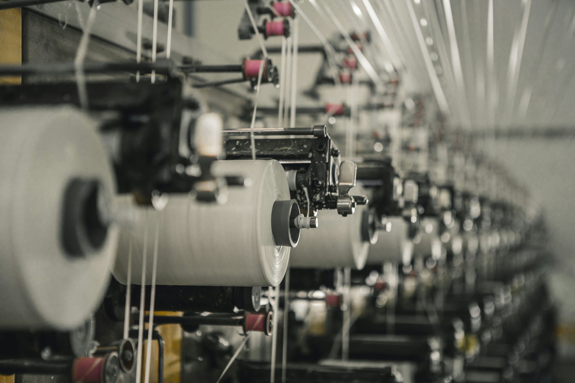 Mill loom in motion — soft luminance backdrop for newsletter signup